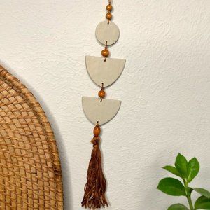 Hand Crafted Tan Clay Wall Art Hanging with brown Tassel and wooden beads
